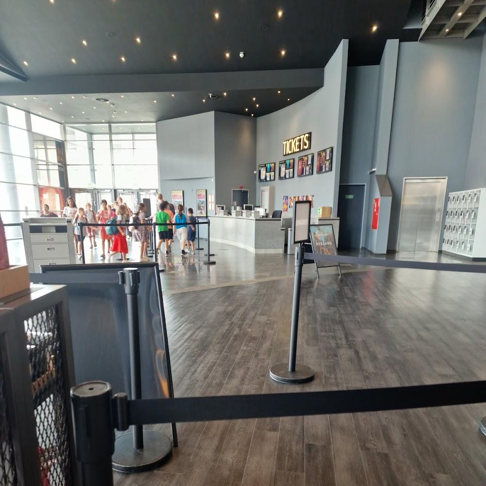 A movie theater lobby with a ticket booth.